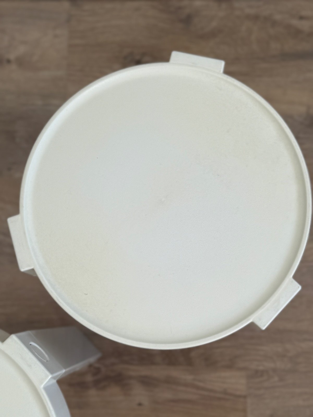 Zoom sur le plateau d'une table blanche Prisunic en plastique blanc